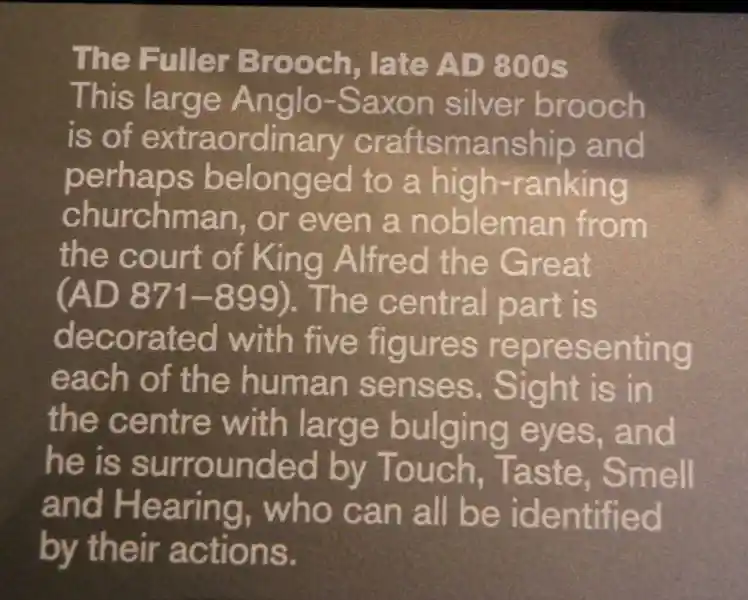 An angel, a cross and solar disc on a brooch